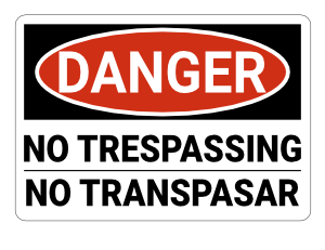 Bilingual English and Spanish No Trespassing Danger Sign